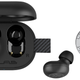 The JLab JBuds Mini open charging case revealing the buds inside, compared in size to a US quarter, photographed on a white background.